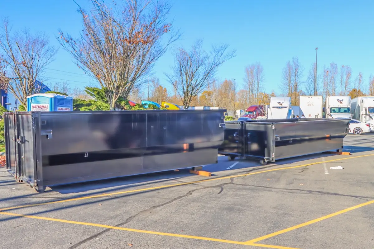 Professional dumpster rental service with roll-off container on residential driveway in Berkley